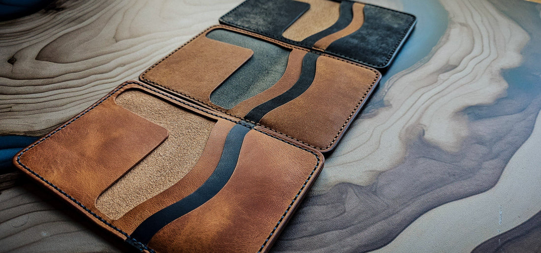 Collection of handcrafted leather wallets displayed together, illustrating the shared visual language and naming systems that connect different carry objects within the studio.