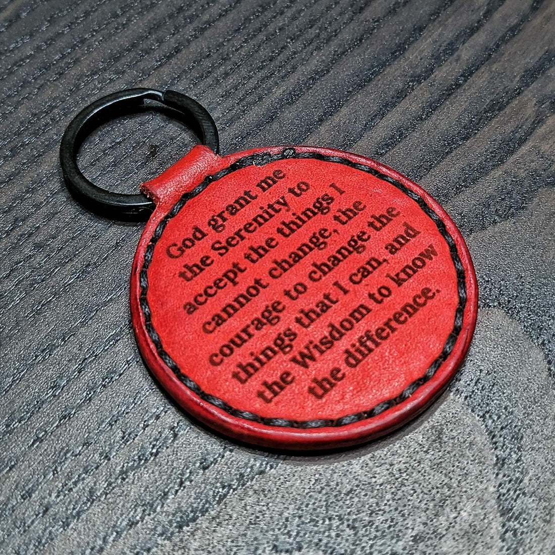 Engraved leather keychain carrying a personal inscription, reflecting how everyday objects accumulate memory, meaning, and identity through long-term use.
