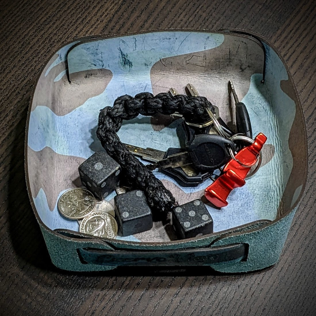 Leather valet tray holding keys, coins, and everyday carry items, demonstrating organization and daily ritual storage.