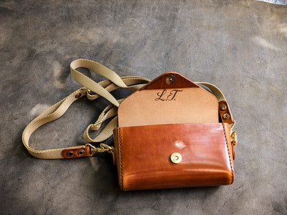 Open Renee crossbody bag displaying the leather-lined interior, organizational pockets, and storage compartments.