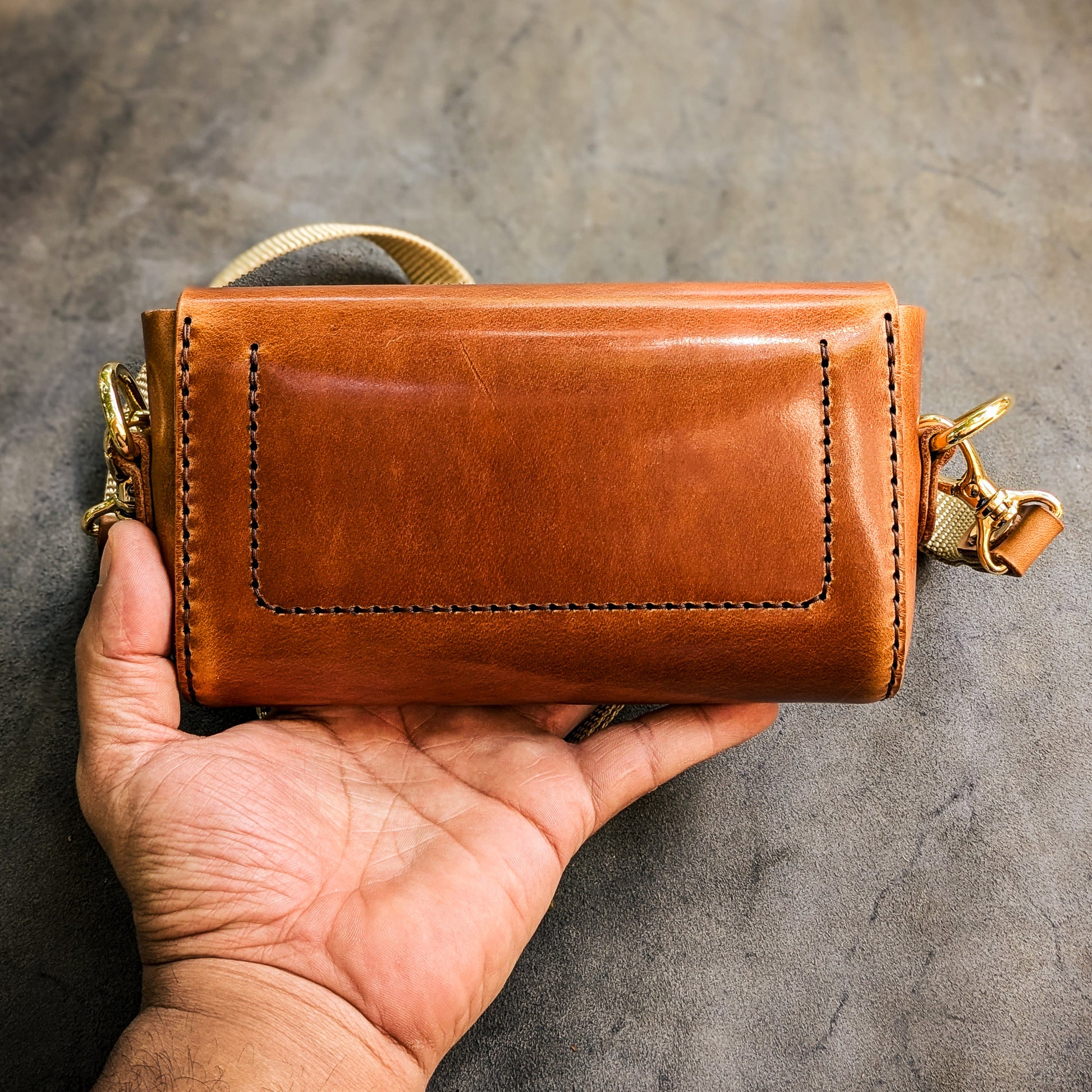 Rear view of the Renee crossbody bag showing handcrafted leather construction, stitching details, and structured back panel.