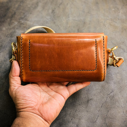Rear view of the Renee crossbody bag showing handcrafted leather construction, stitching details, and structured back panel.