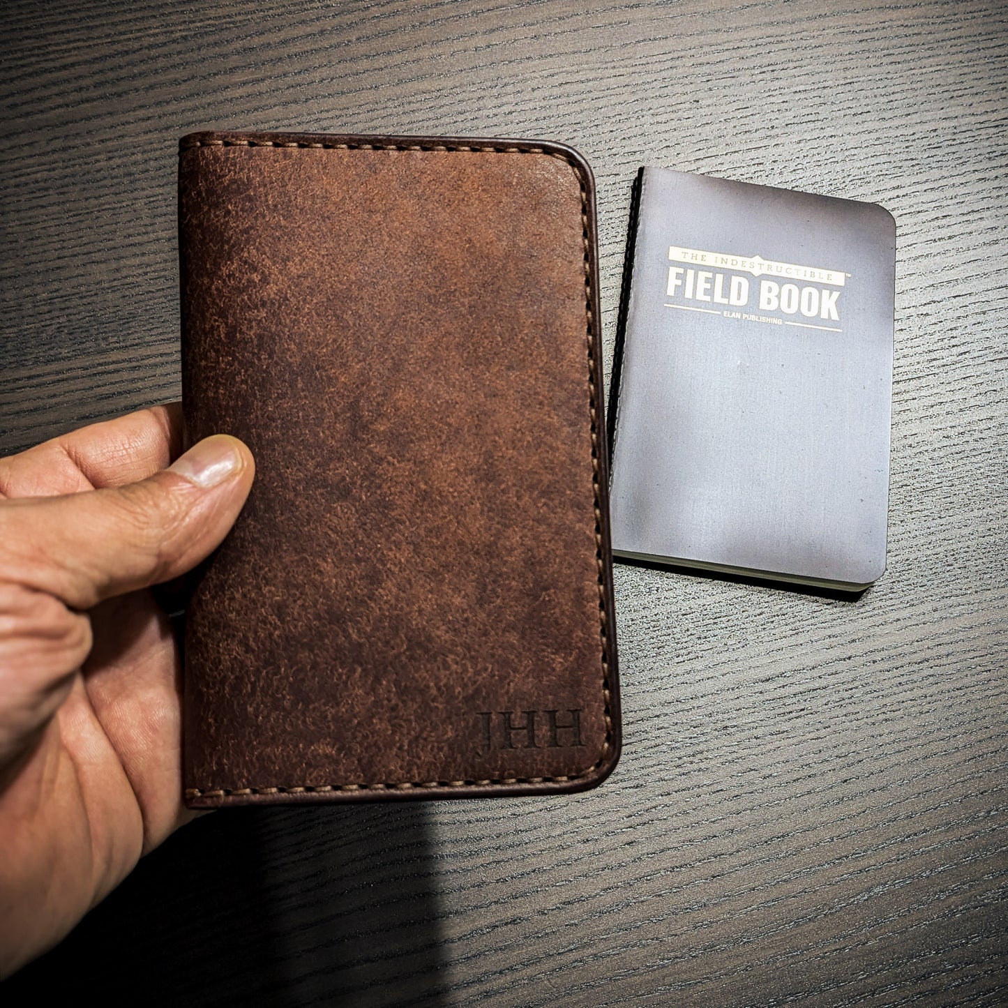Old Crow leather Field Notes cover shown in hand for size reference