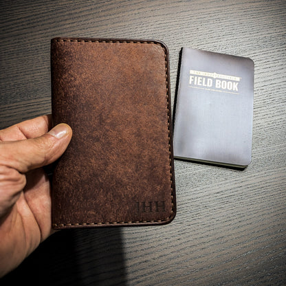 Old Crow leather Field Notes cover shown in hand for size reference