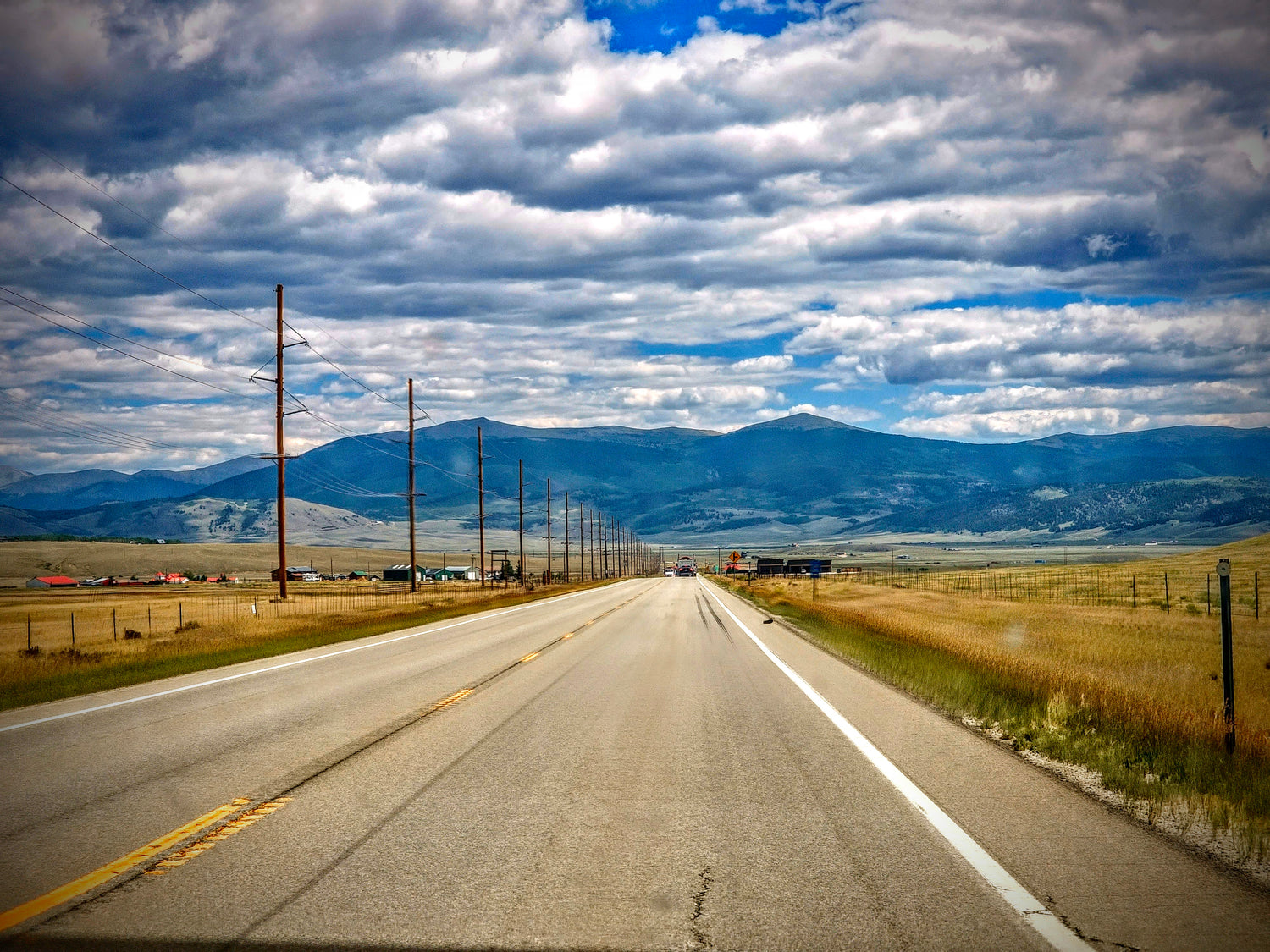 Open highway leading toward the Colorado Front Range mountains, symbolizing the studio's relocation from North Carolina and the beginning of a new chapter.