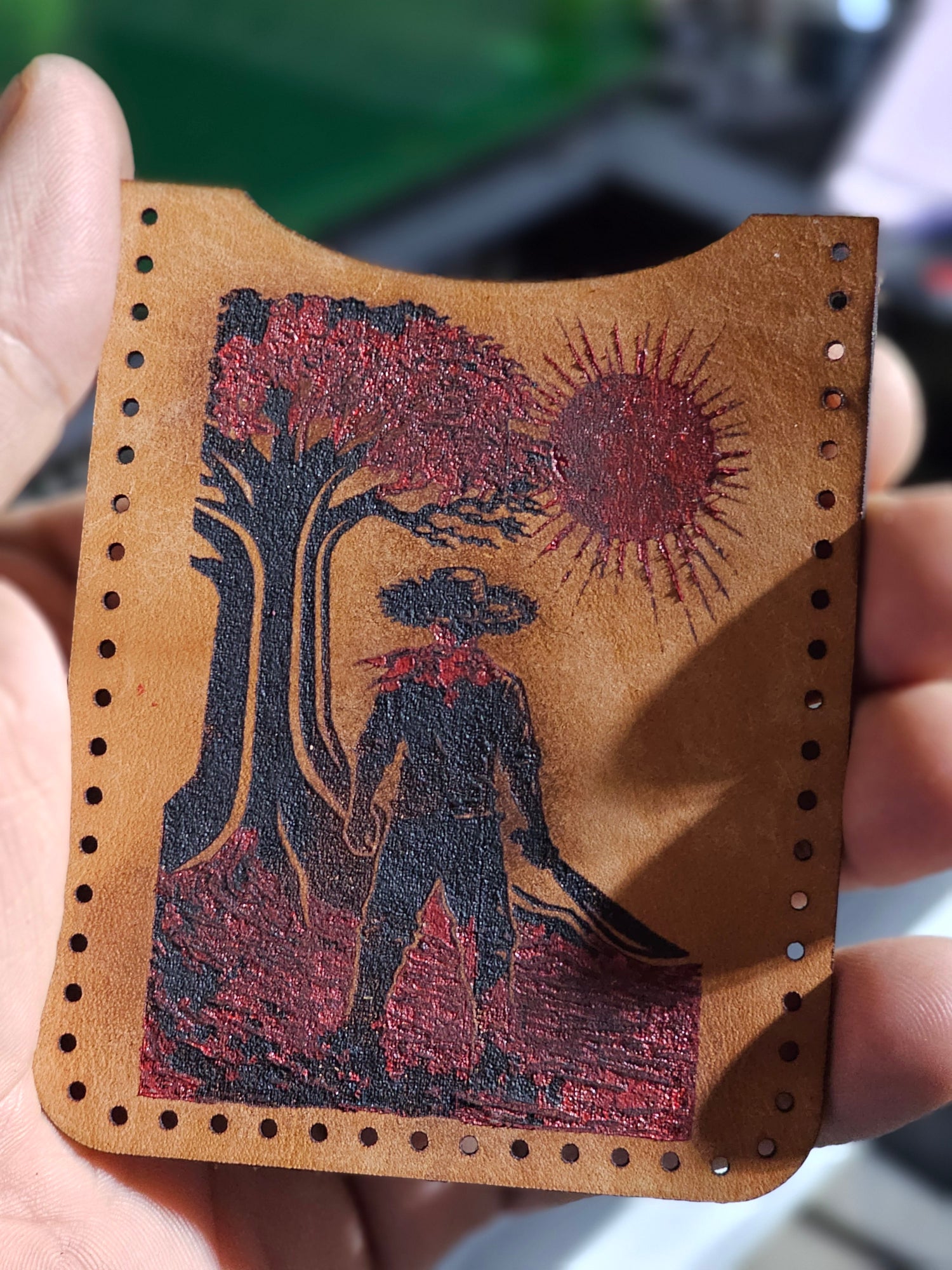 Laser-engraved leather wallet panel featuring a jíbaro figure rendered in a Japanese-inspired linocut style, exploring memory, identity, and layered surface translation.