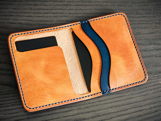 Westfield leather bifold wallet opened to show layered interior pocket construction