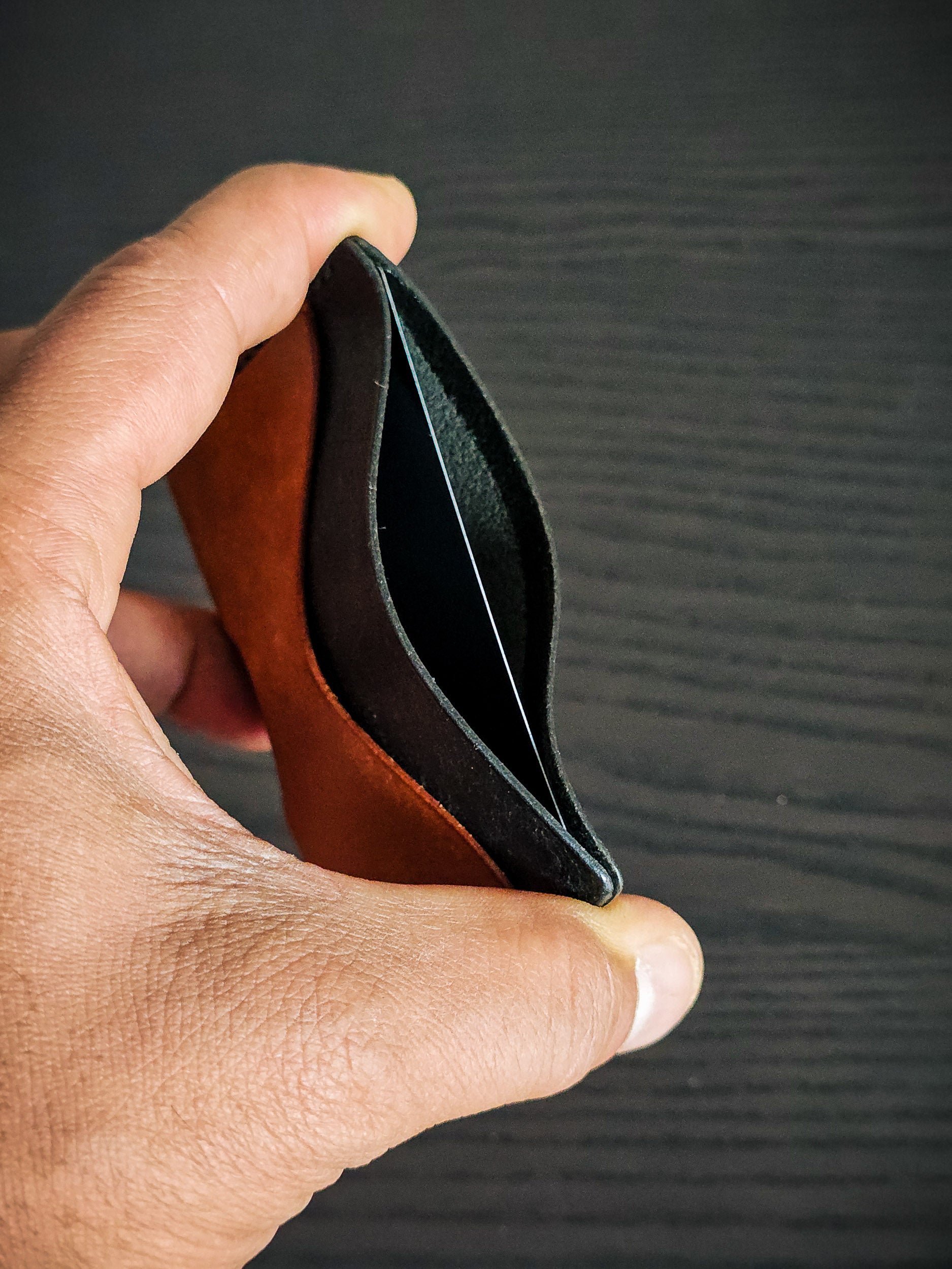 Wingman leather cardholder showing folded profile and card capacity