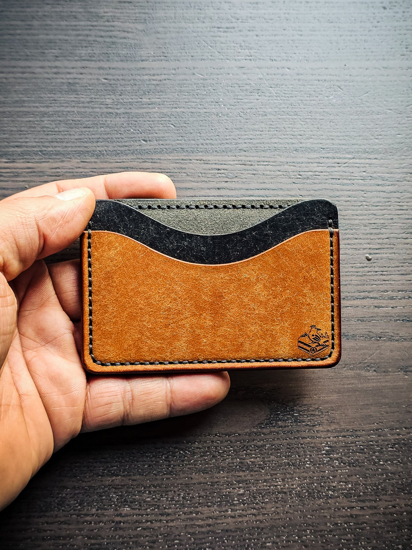 Sidekick leather cardholder shown in hand for size reference
