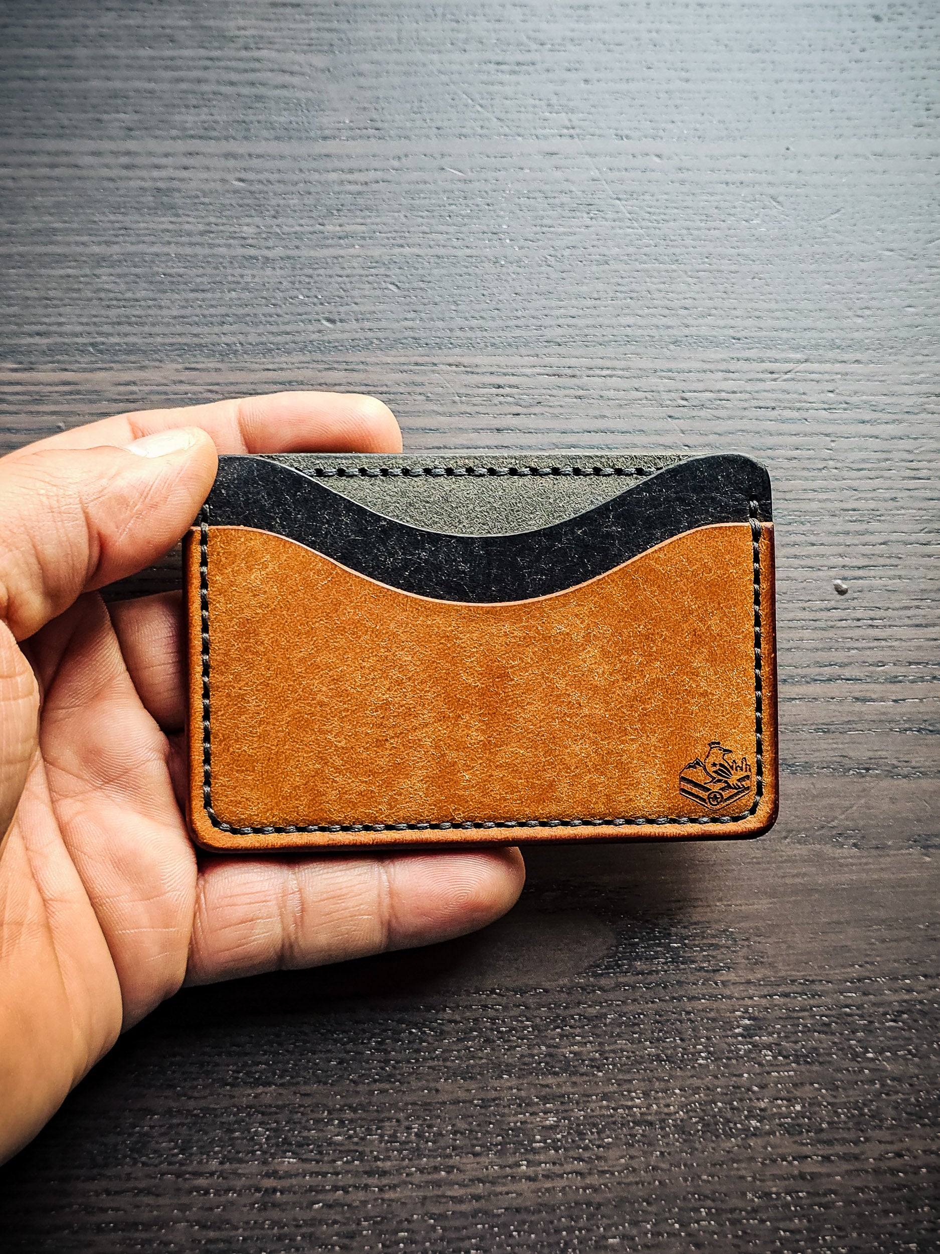 Sidekick leather cardholder shown in hand for size reference