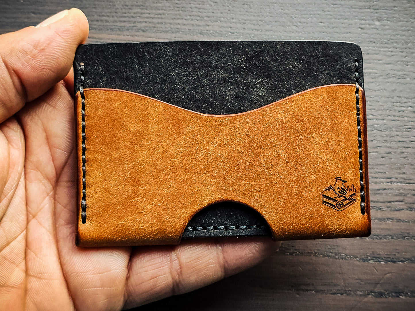 Wingman leather cardholder shown in hand for size reference