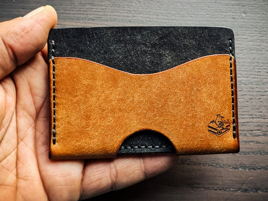 Wingman leather cardholder shown in hand for size reference