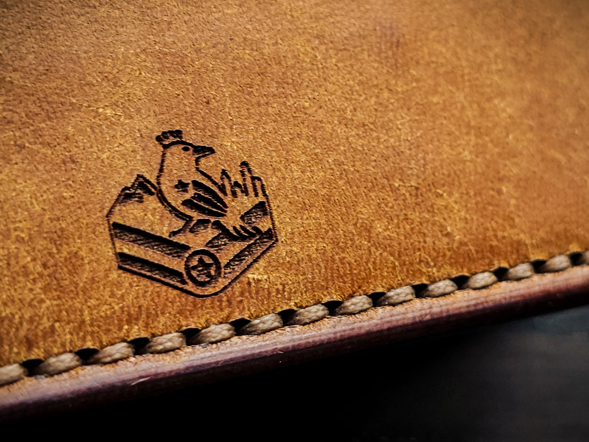 Maker's mark and hand-stitched edge detail on Westfield leather bifold wallet