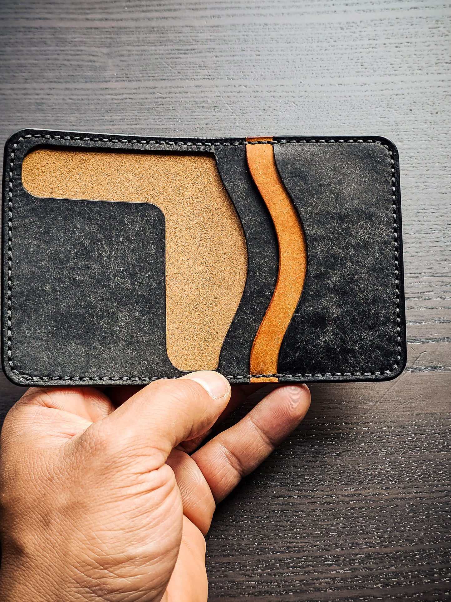 Westfield leather bifold wallet shown in hand with interior card storage