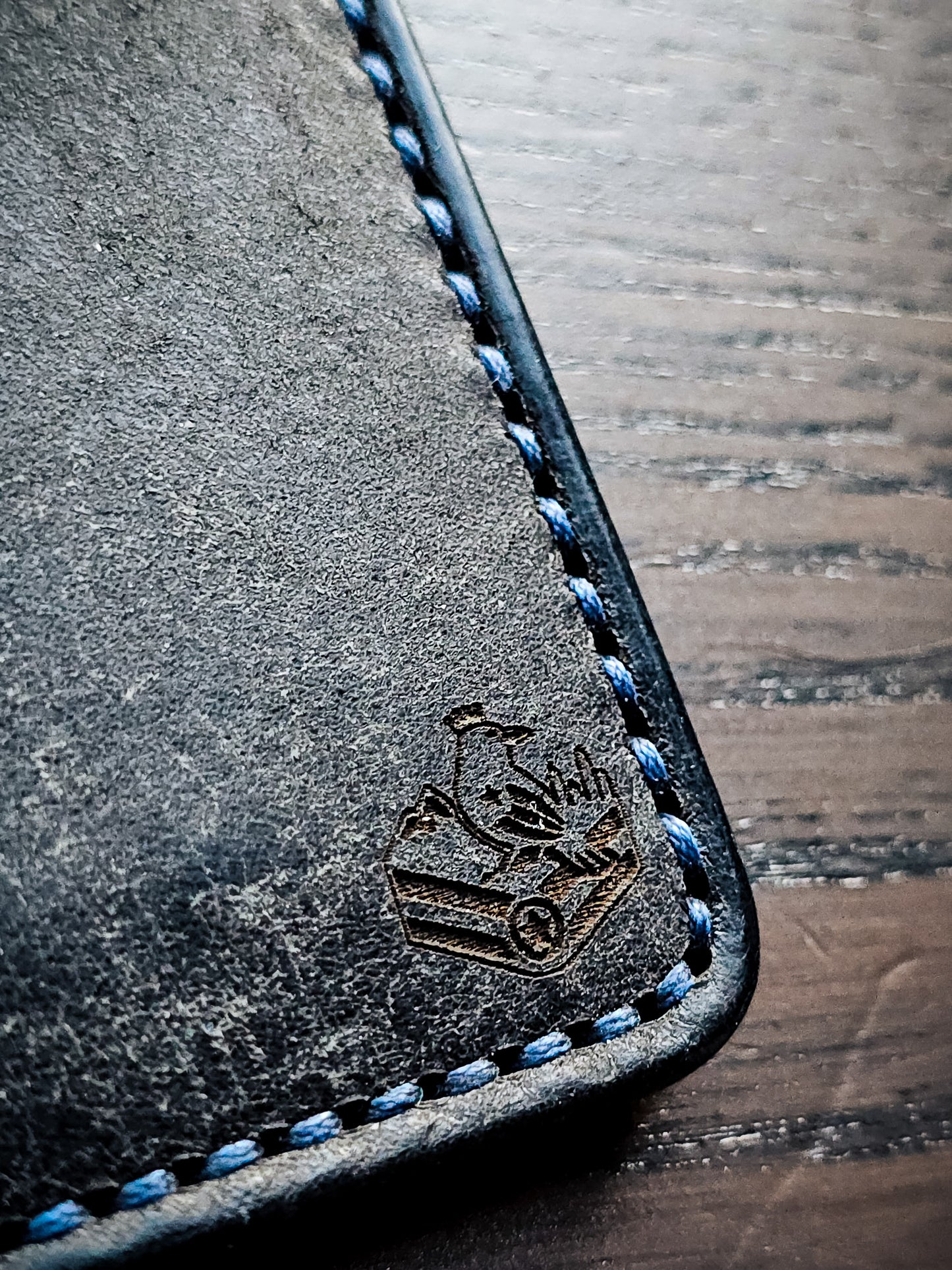 Maker's mark and hand-stitched edge detail on Eastland leather bifold wallet