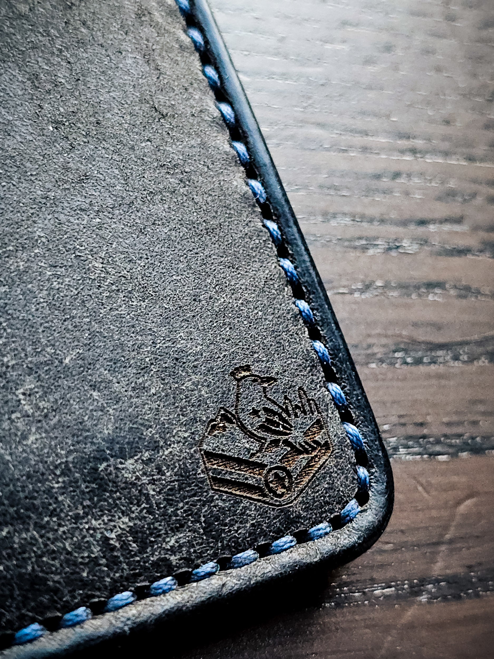 Maker's mark and hand-stitched edge detail on Eastland leather bifold wallet