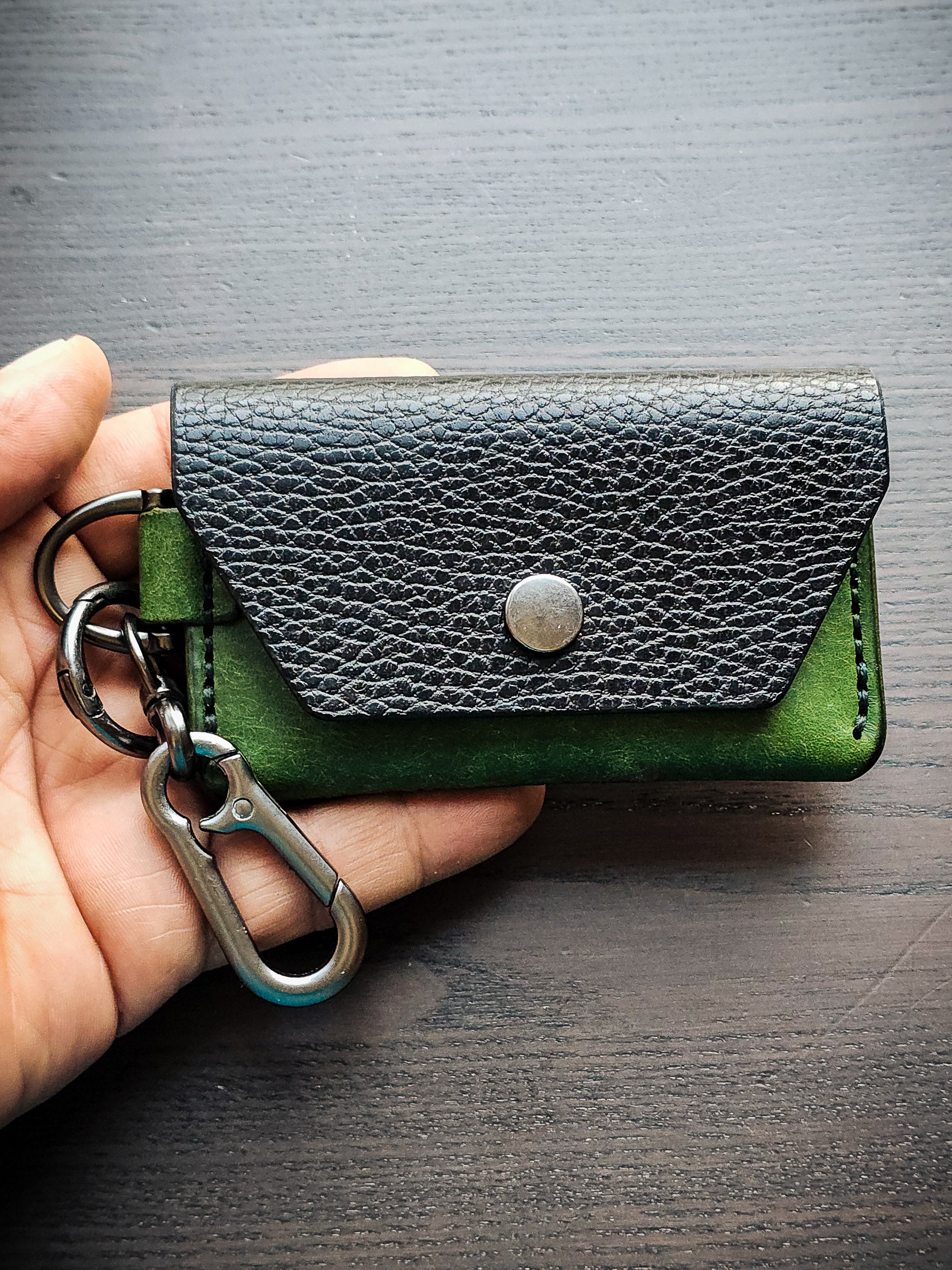 Latchkey leather keychain wallet shown in hand for size reference