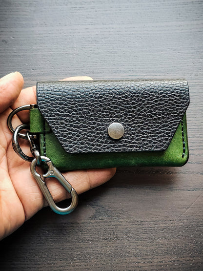 Latchkey leather keychain wallet shown in hand for size reference