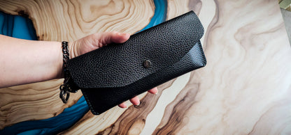 Delilah Clutch held in hand to demonstrate size, carry style, and handcrafted construction.