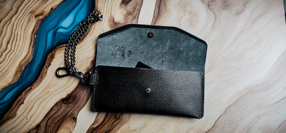 Front view of the Delilah Clutch highlighting the envelope-style flap and silver snap closure.