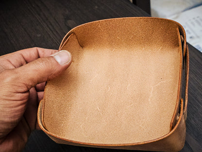 The Nest leather valet tray held in hand to demonstrate size, proportions, and compact everyday carry storage capacity.